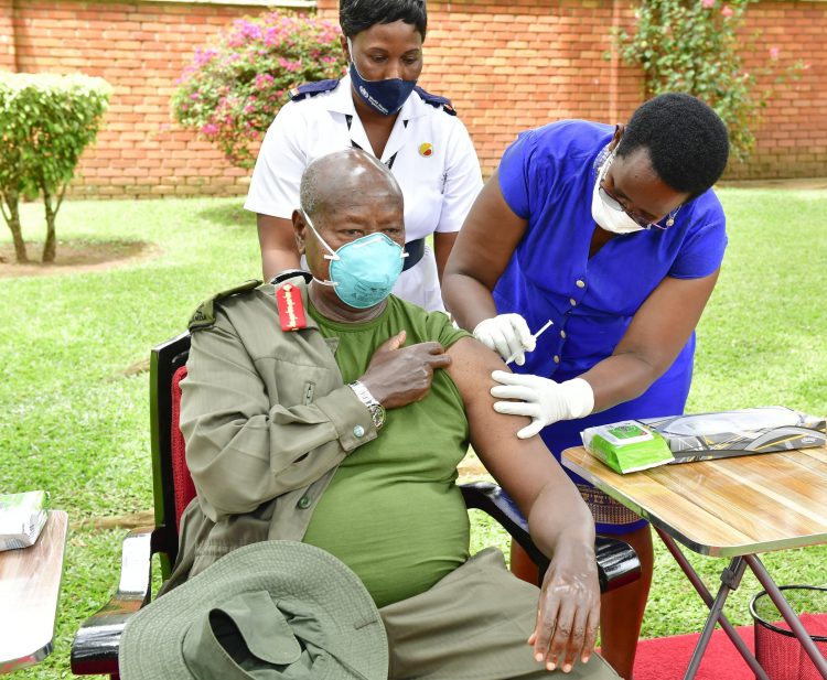 Health Ministry Permanent Secretary, Dr. Diana Atwine vaccinating Museveni