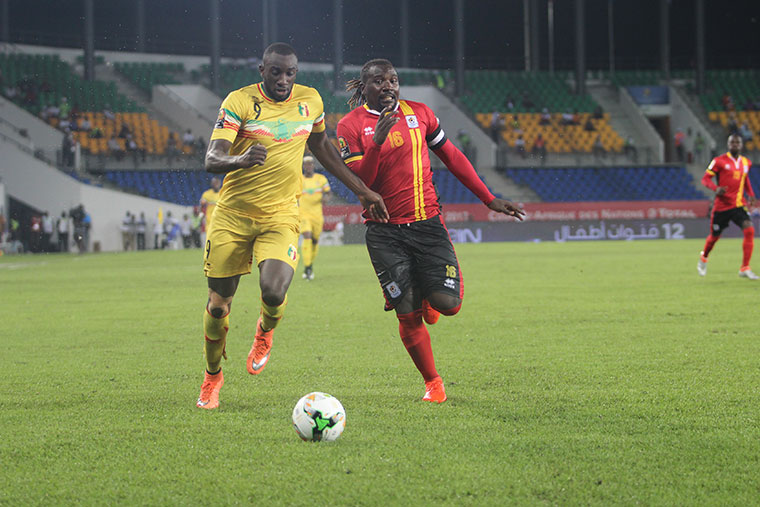 Hassan Wasswa (In red and black) playing for Uganda Cranes