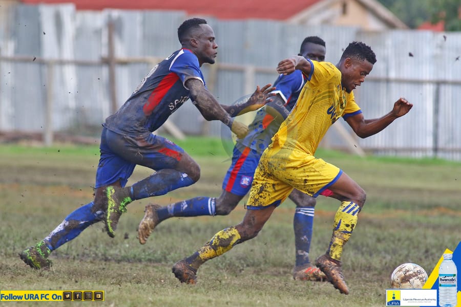 Saidi Kyeyune (yellow) taking on SC Villa players