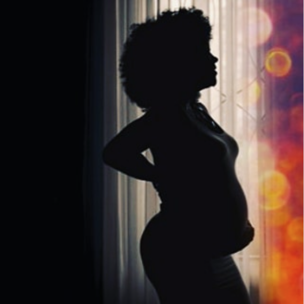 Anne Kansiime showing off baby bump