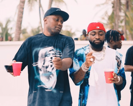 Davido and manager, Isreal Afeare (L)