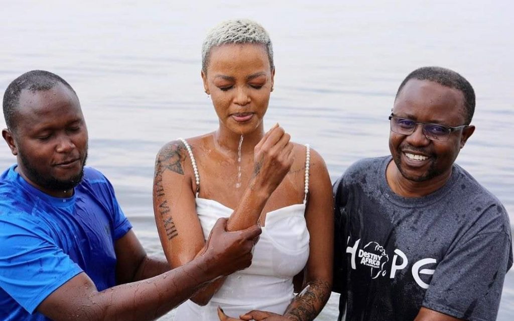 Nina Roz getting baptized by Bishop, Muwonge