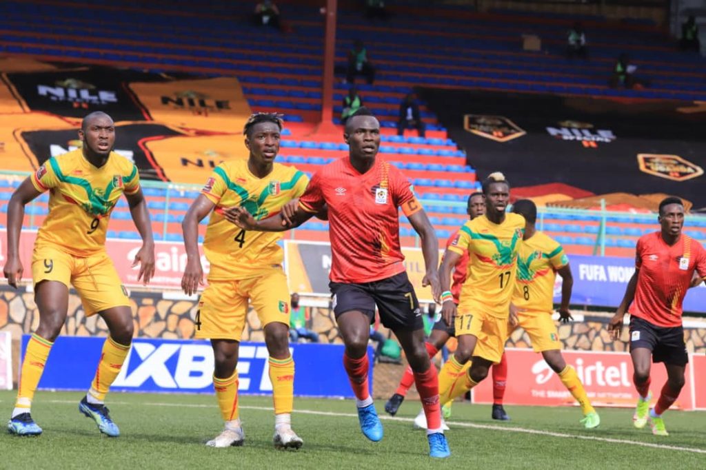 Emma Okwi focusing on the ball as he battles Mali defenders