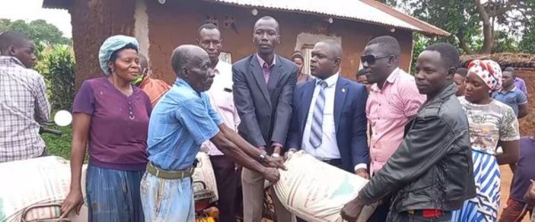 Godfrey Jjemba receiving building materials from well wishers