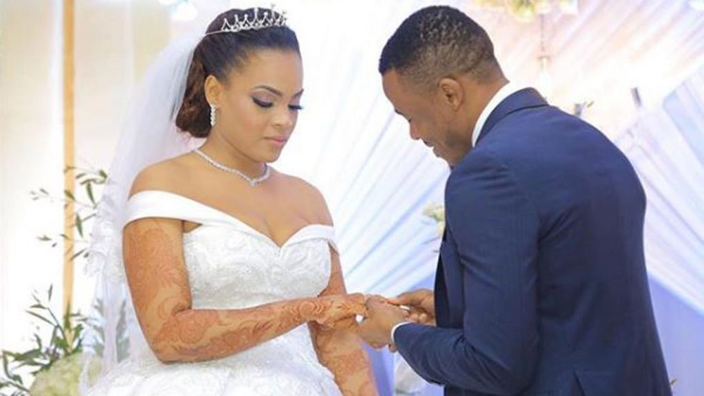 Ali Kiba slips a ring on the finger of his wife Amina Khalef during their wedding in Dar es Salaam