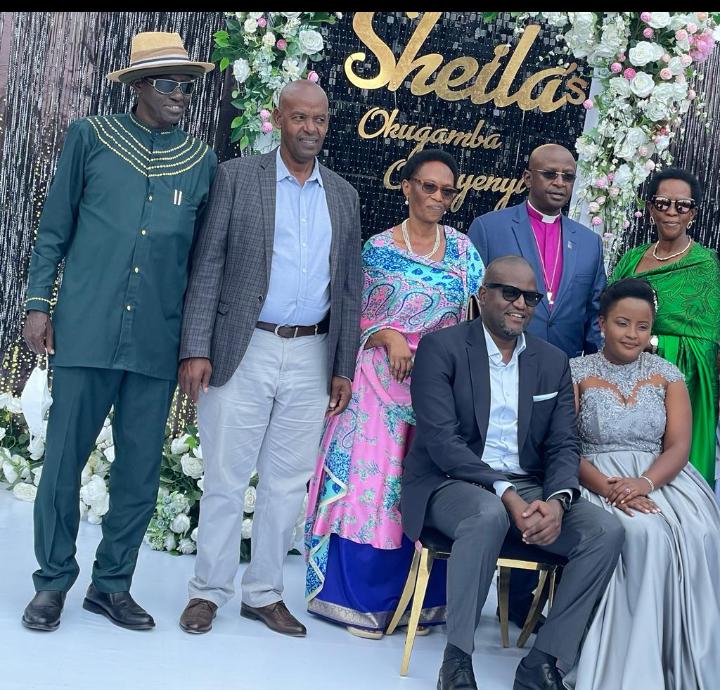 Sheila Nduhukire (R) from row next to hubby surrounded by parents and guests