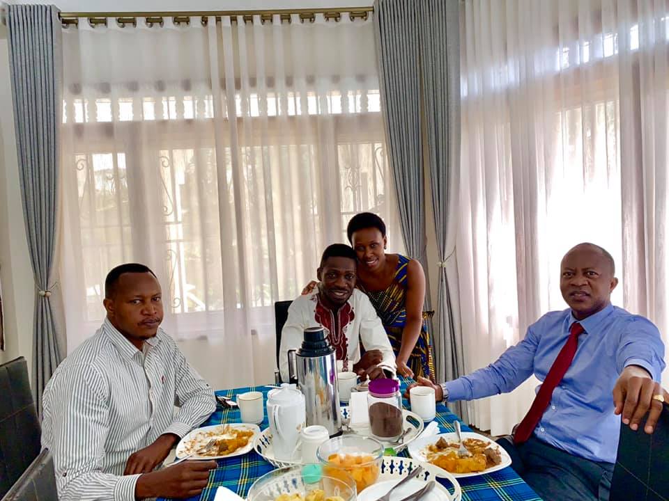 Frank Gashumba (L) dining with Bobi Wine and wife