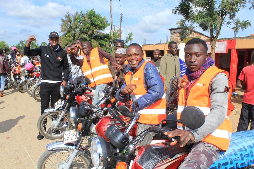 Muhangi takes a photo with Nyahuka bodaboda riders after gifting them with reflector jackets