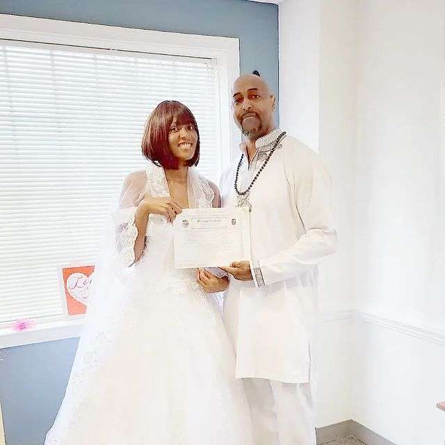 Doreen Kabareebe and Corey Harris showing off marriage certificate