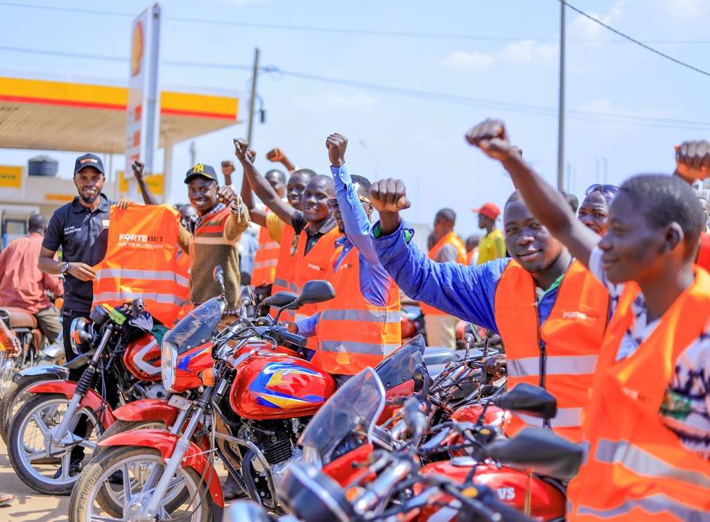 Muhangi giving out reflector jackets to bodaboda riders